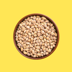 Pistachios in a clay bowl.