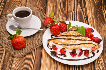 Crepes with Banana, Chocolate and strawberries with cup of coffee.