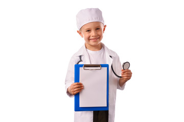 A  little, smiling boy doctor in  medical uniform, isolated on white, with stethoscope on the neck,  reminds you about health care and healthy lifestyle. Waist up portrait, looking at camera.