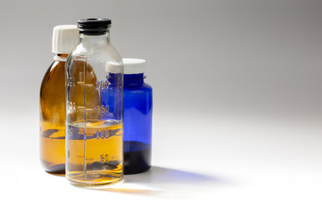 colored medial bottles on gray background with copyspace