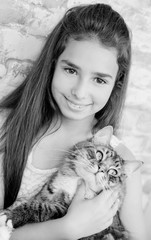 pretty girl teenager 10-11 years holding a cat
