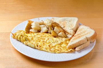 scrambled eggs with potatoes and toasts. American breakfast food