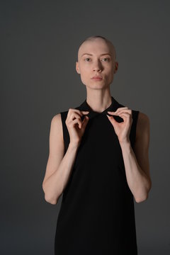 Bald Girl Posing In Studio In Black Dress