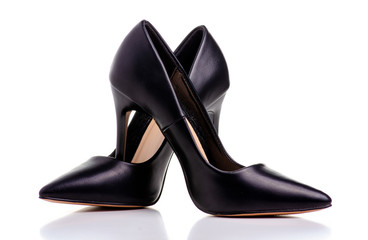 Female black leather high heels shoes on white background isolation