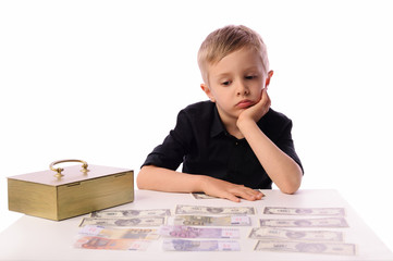 A little boy, 5 years old, plays with gold bars. He works in the bank as a security guard. The...