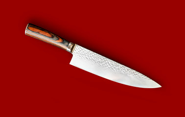 Chef's knife for your kitchen isolated on red