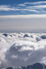 Snowy mountains covered with beautiful sunlight clouds