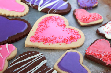 Heart Shaped vanilla and chocolate cookies with pink and purple icing for Valentines day