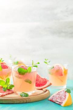 Fresh pink alcoholic cocktail with grapefruit, ice and mint