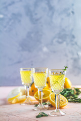 Liqueur limoncello with pieces of lemon and rosemary herb