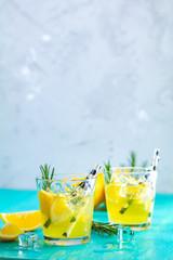 Cocktail with ice, lemon and rosemary herb