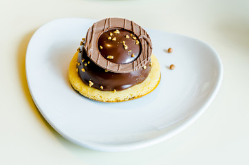 Cake on a plate in the form of a heart. Dessert for lovers