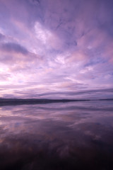 Brilliant pastel pinks and purples in sunrise over still waters of Lake Carmi in Franklin, VT, USA