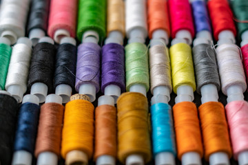 bunch of colorful sew threads lay on dark background isolated d