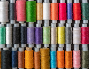 bunch of colorful sew threads lay on dark background isolated d