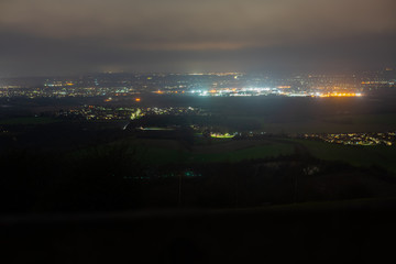 Bright lit cottage in countryside with surrounding villages and town