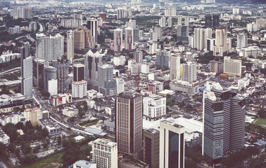 Fototapeta na wymiar Kuala Lumpur cityscape on a rainy day, color toned picture, Malaysia.