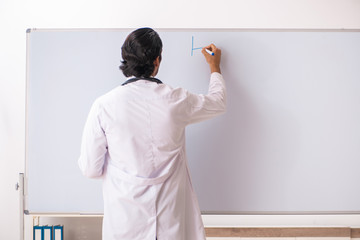 Young doctor in front of whiteboard 