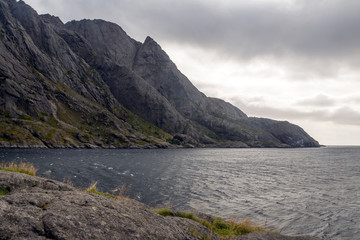 Mountains by the sea in Lofoten, Norway on a cloudy day