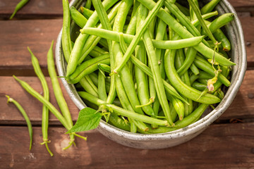 Raw green beans in an old aluminum pot