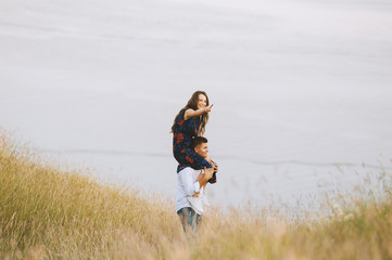 Photo of having fun couple in meadow