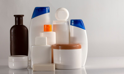Banner Hair and body care cosmetics white bottles on white background Copy space selective focus