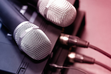 radio microphones. wireless sound transmission system. Microphones are on the receiver. Audio wires are connected. soft focus Two mic