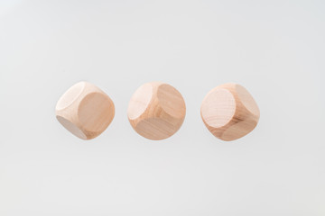 Abstract floating wooden dice on white background