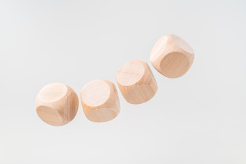 Abstract floating wooden dice on white background