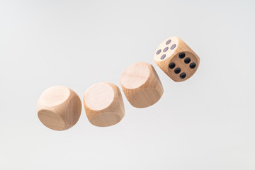 Abstract floating wooden dice on white background