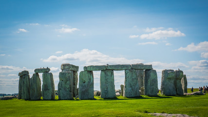 Stonehenge unesco world heritage site on sunny day, Salisbury in England. Summer holidays destination in the UK, Europe. Green countryside landscape with blue sky on a summer day in Great Britain.