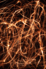 Long exposure underexposed photo of lightpainting bengali fire. Lighdrawing photo. Soft focus and a lot of lines.