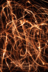 Long exposure underexposed photo of lightpainting bengali fire. Lighdrawing photo. Soft focus and a lot of lines.