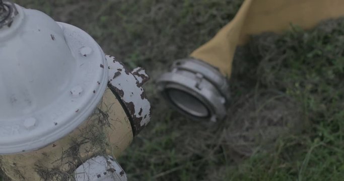 Old fire hydrant with yellow firehose