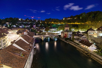 Fototapeta na wymiar Untertorbrücke bridge on the Aare river seen in the night from the Nydeggbrucke, Bern, Switzerland