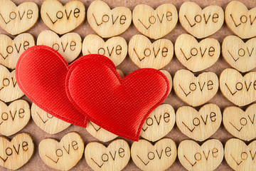 Many wooden natural hearts with an inscription love