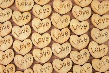 Many wooden natural hearts with an inscription love