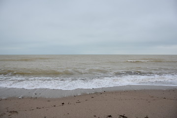 Fototapeta na wymiar Winter sea and the beach in shades of creme brulee