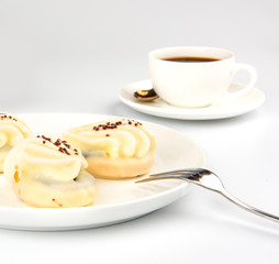 Mini yellow cakes on white background