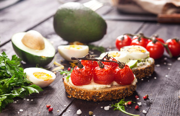 Set of different bruschettas on dark wooden table.