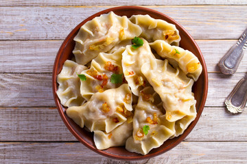 Dumplings, filled with potato. Varenyky, vareniki, pierogi, pyrohy - dumplings with filling. View from above, top studio shot