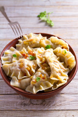 Dumplings, filled with potato. Varenyky, vareniki, pierogi, pyrohy - dumplings with filling