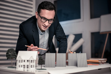 Professional smart malen salesman holding a pencil