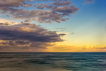 Fototapeta na wymiar Beautiful colorful clouds over the sea. Amazing sky after sunset.