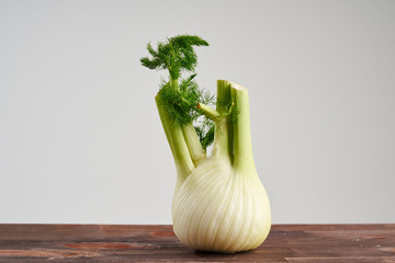 Fresh fennel on wooden background. Concept of healthy food and nutrition.