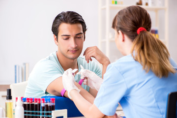 Young patient during blood test sampling procedure  