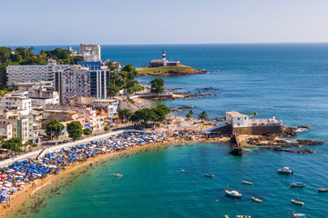 Aerial view of Salvador da Bahia, Brazil, showing Porto da Barra beach and historical landmarks Barra Lighthouse and Santa Maria Fort