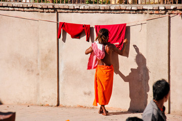 Monk in Nepal hang up his clothes to dry