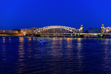 Peter the Great Bridge over the Neva river embankment. White nights in St. Petersburg, Russia. Bolsheokhtensky Bridge.