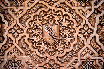 Detail of Islamic stone carving on a wall in the royal palace Nazaries of the Alhambra, Granada, Andalucia, Spain - obrazy, fototapety, plakaty